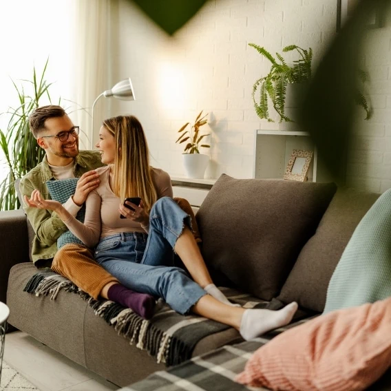 happy couple relaxing in their clean home