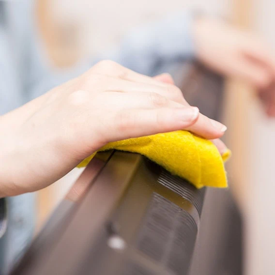 cleaner wiping down all dust from a flat screen tv