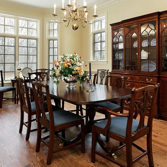 elegant dining room with large dinner table and china hutch