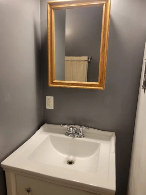 clean bathroom view of vanity and mirror