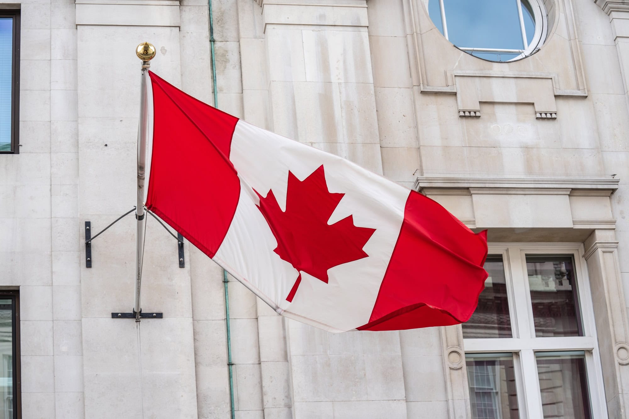 government building with canadian flag flying