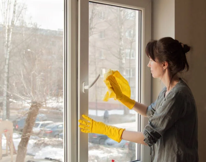 a woman washes a window